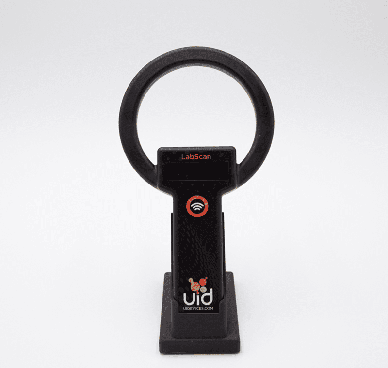 URH-2 handheld reader seated upright in the black URH-2 charging dock, shown face-on