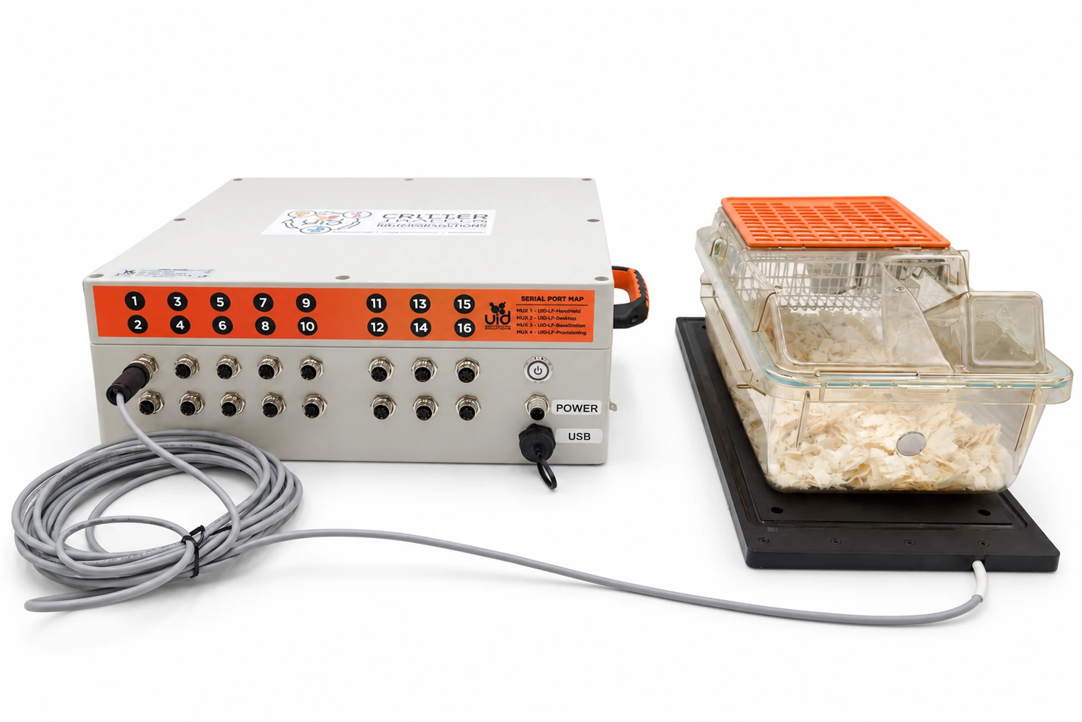 Critter Tracker controller connected to a rectangular antenna beneath a home cage